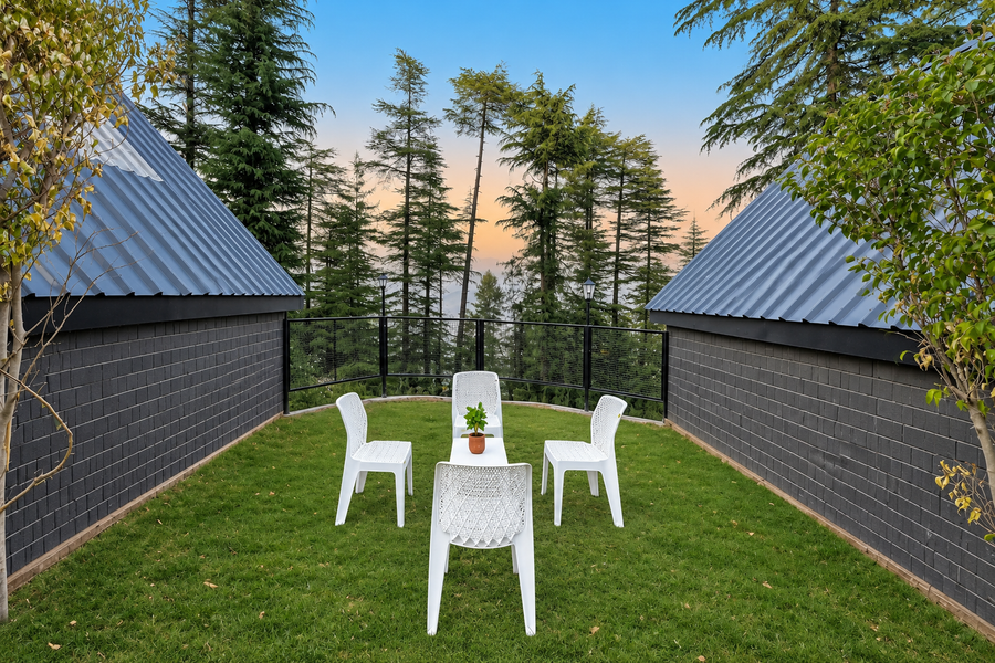 Lush private garden with outdoor seating at a Vanam cottage