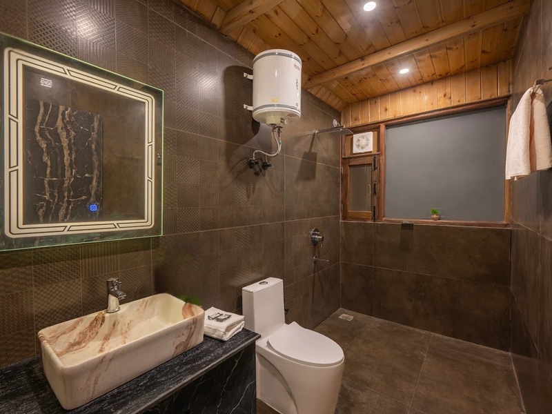 Mountain cottage bathroom with stone tiles and modern fittings